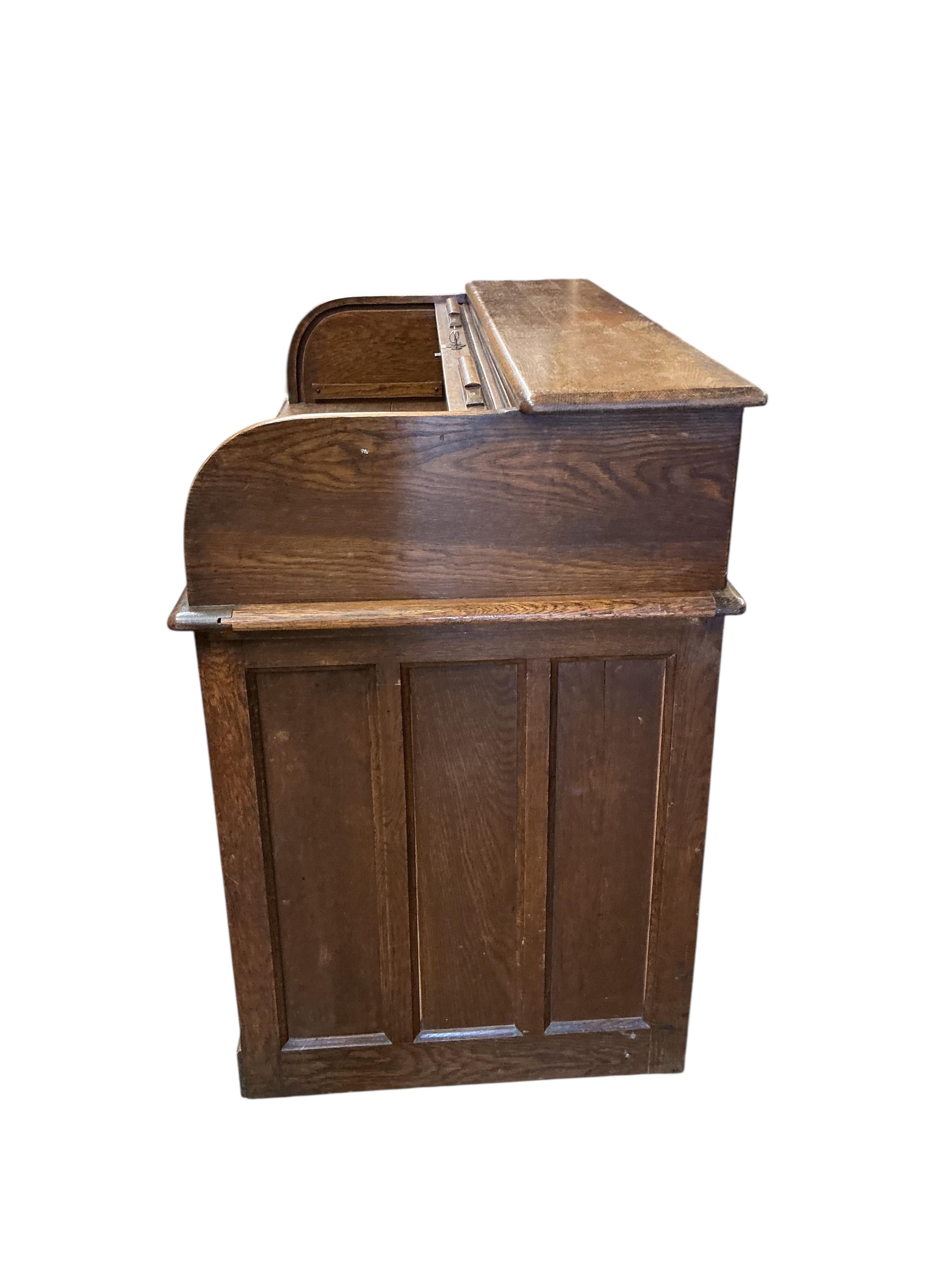 An early 20th century oak roll top desk, width 122cm, depth 66cm, height 101cm